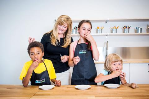 Jodie Fitz cooking with 3 children.