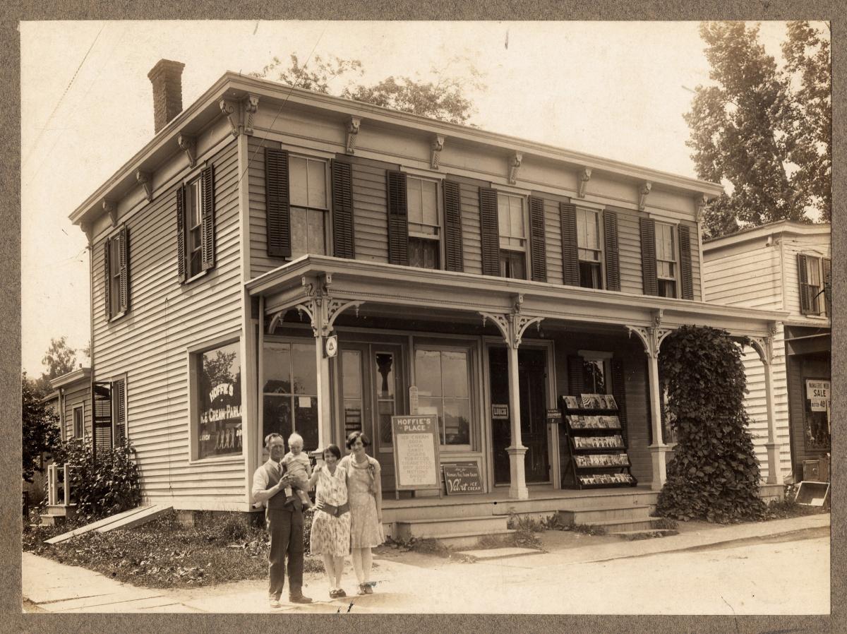 Theron E. Houghmaster and family stand outside their store on 43 S. Main Street in 1928